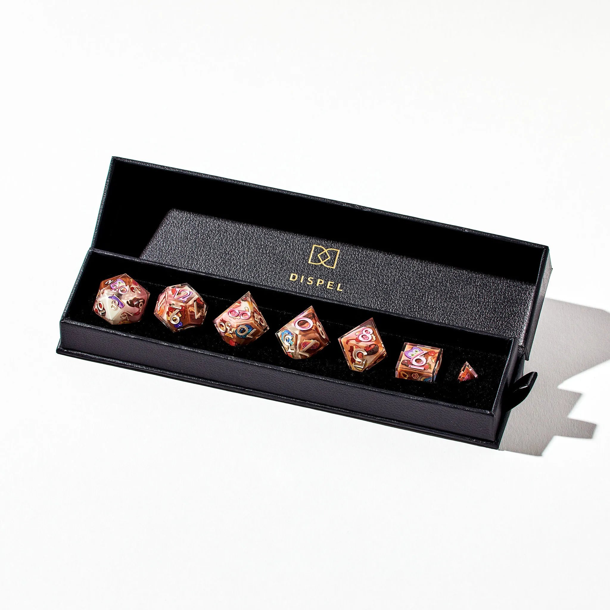 Neapolitan Colored Dice Set for DnD with Cat Themed Pastry Designs in Packaging on a White Background