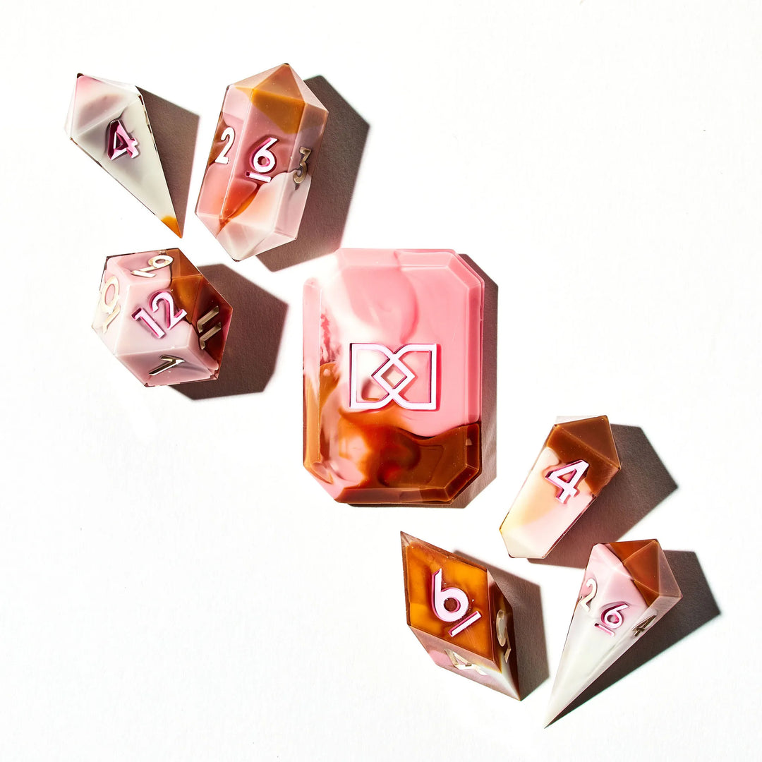 A Brown Pink and White Colored Jewel-Shaped Dice Set on a White Background