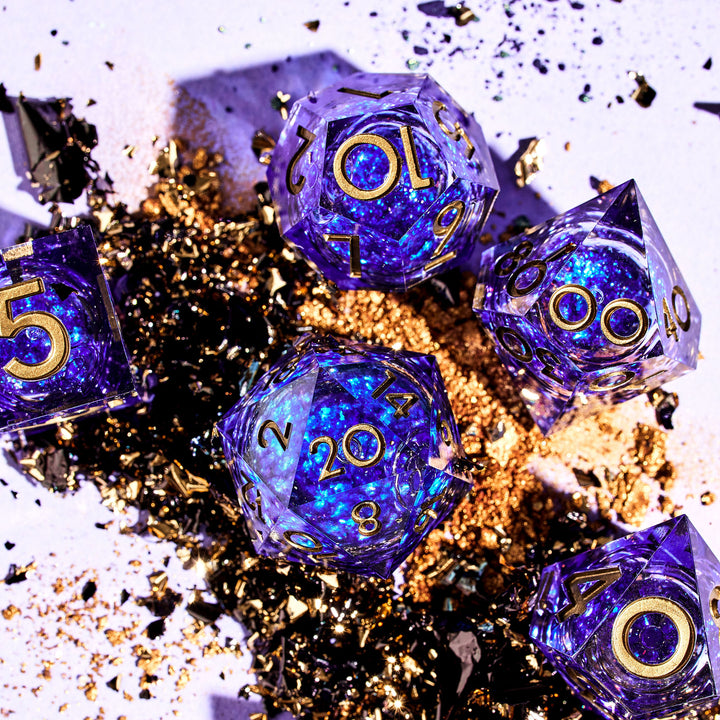 The Weave Blue Liquid Core DnD Dice Set on a gold and white background | Dispel Dice