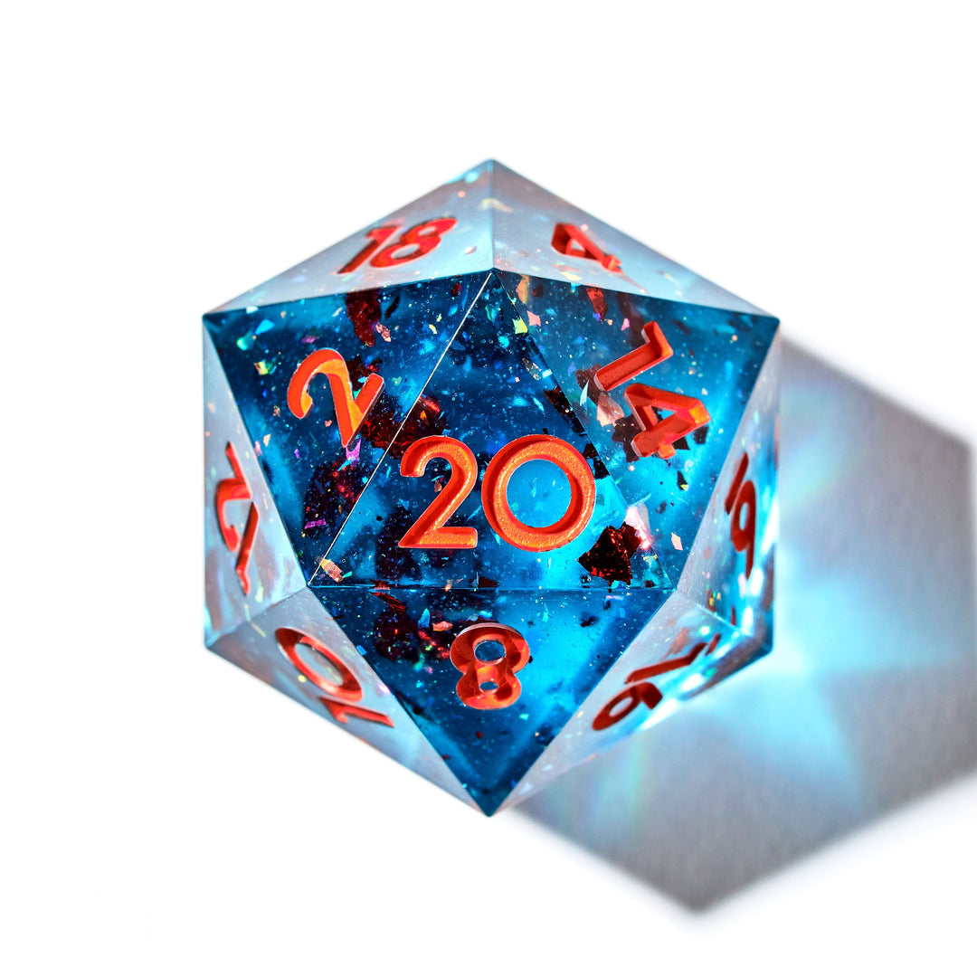 Gorgeous blue D20 with orange flakes and numbering on a white background | Dispel DIce