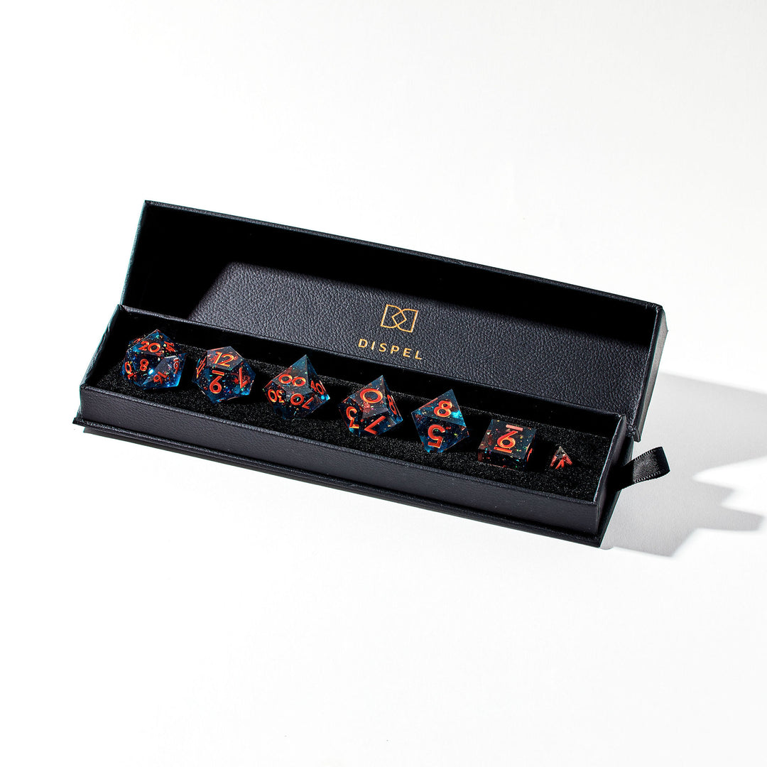 Blue gaming dice set w/ orange flakes and numbering in a permium black box on a white background | Dispel DIce