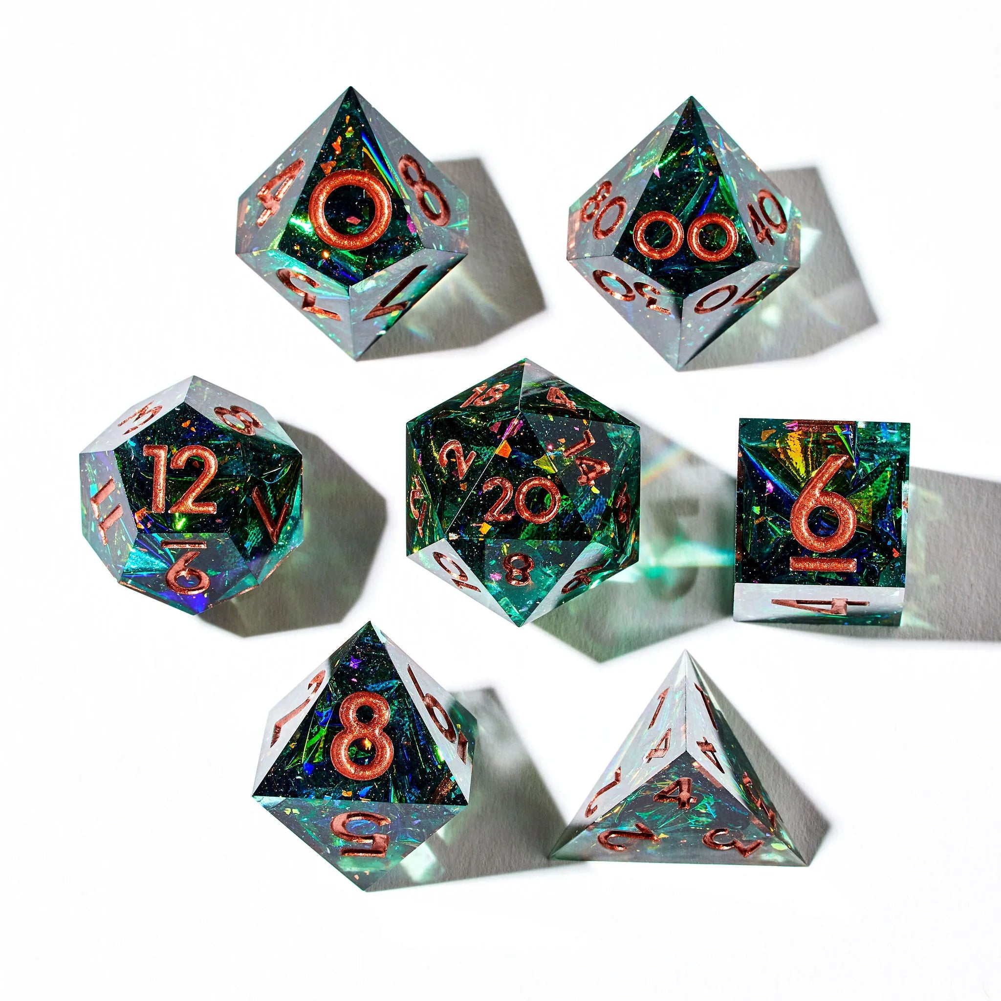 Close Up Photo of a Shining Green 7 Piece Dice Set With Copper Inked Numbers
