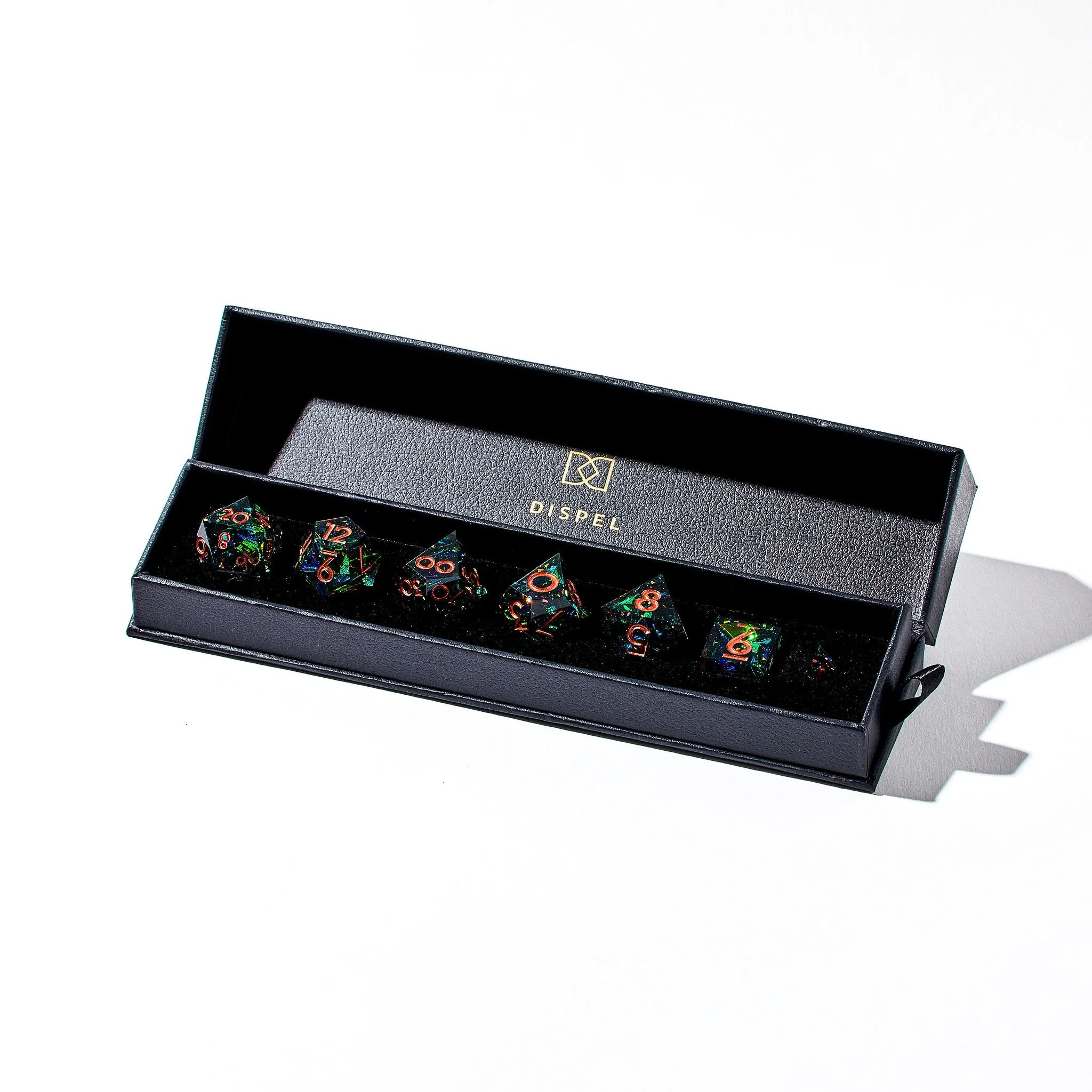 Close Up Photo of a Shining Green 7 Piece Dice Set With Copper Inked Numbers Inside Packaging