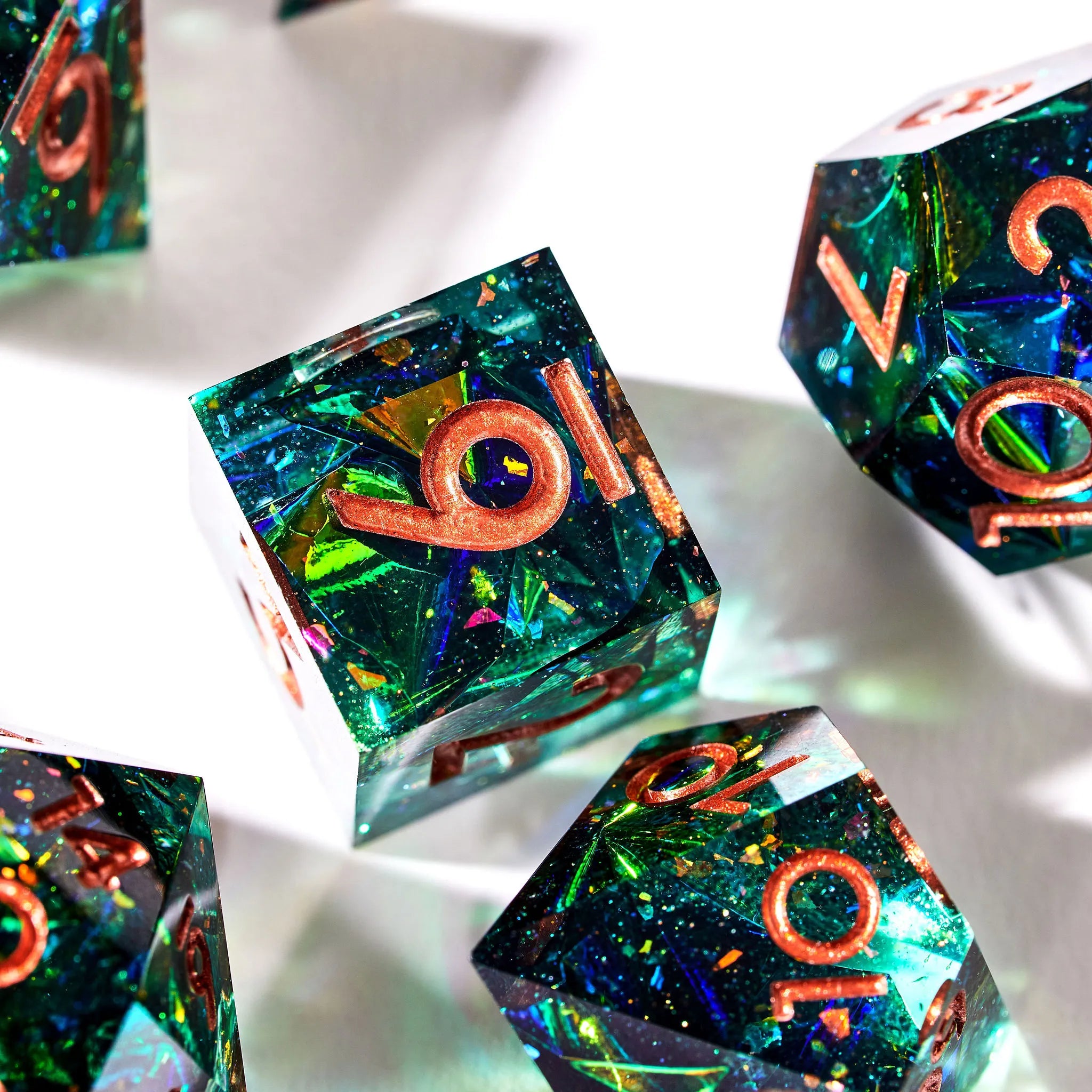 Close Up Photo of a Shining Green D6, D12, D8, D20, and D100 Dice With Copper Inked Numbers