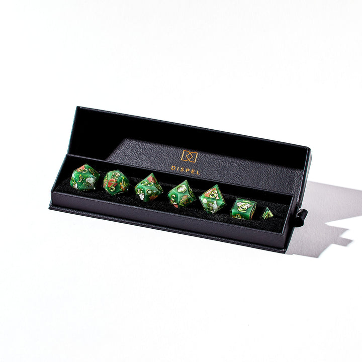 Close up of a green dice set with bear owl designs in the packaging