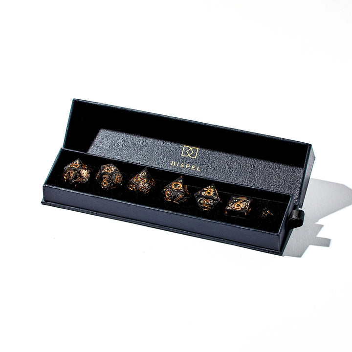 Picture of a full black DnD dice set with copper cogwheel designs and copper inked numbers inside the packaging