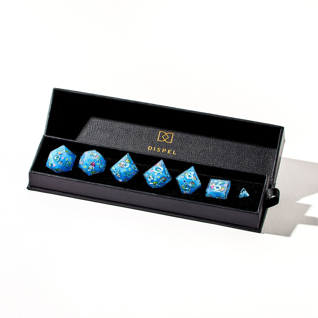 Close up of a light blue dice set with light blue numbers and gachapon capsules inside the packaging