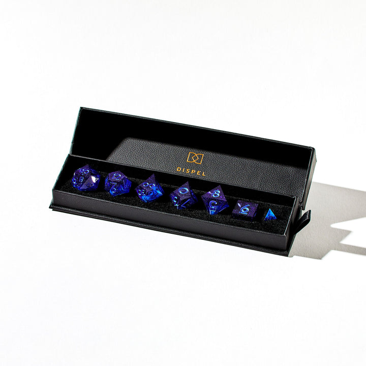 Close up of a blue dice set in the packaging