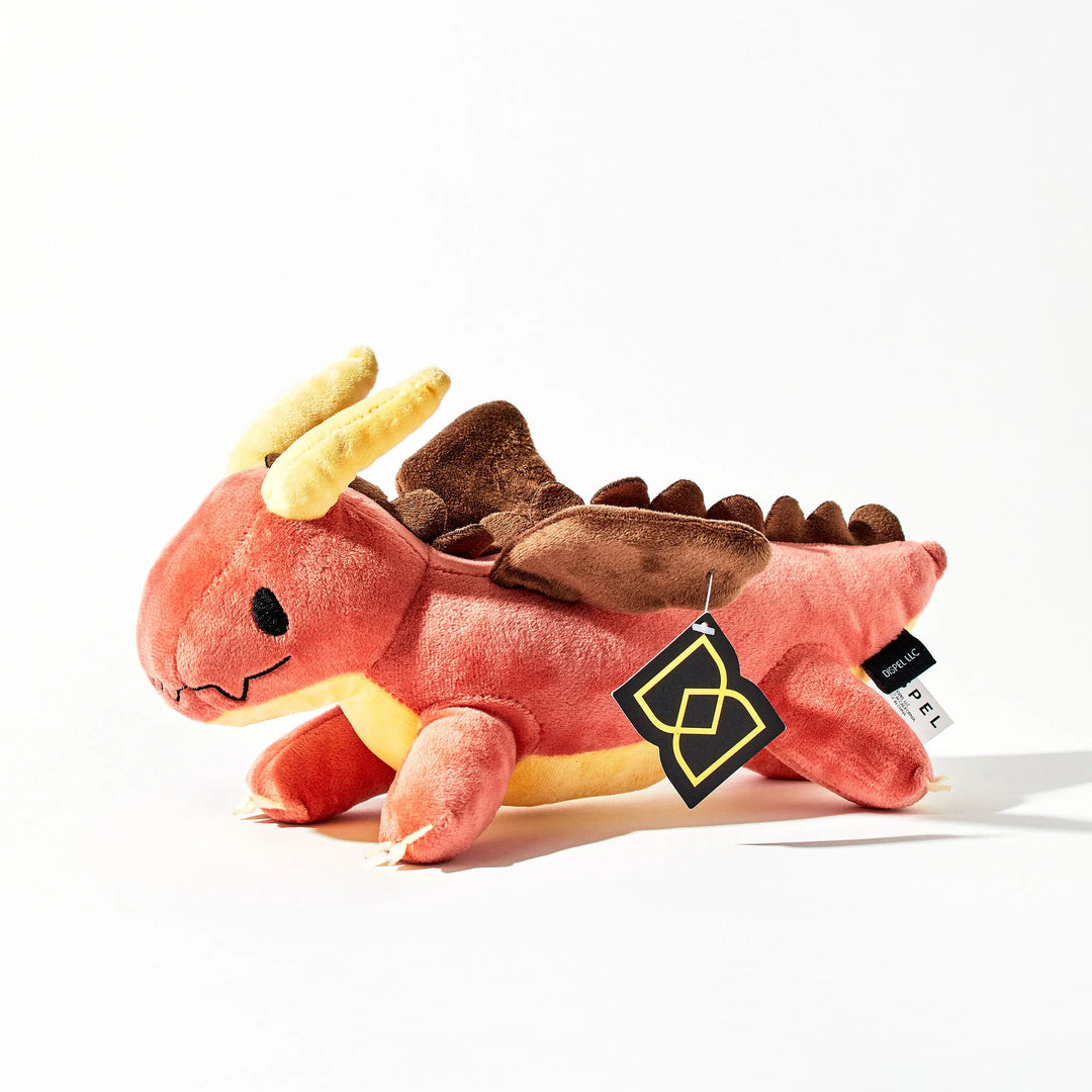 A Plush toy that looks like a Red Dragon on a White Background
