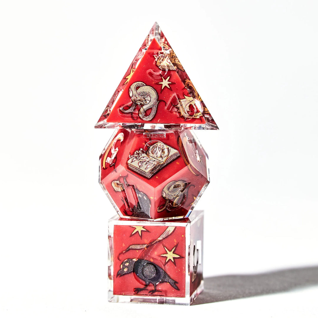 Picture of a small dice tower with a red d4, d12, and d6 with otherworldly decals and yellow inked numbers