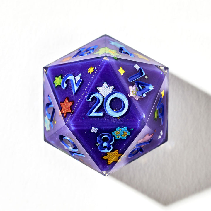 Close up of a purple D20 die with light blue inked numbers and Konpeitō stickers on each face