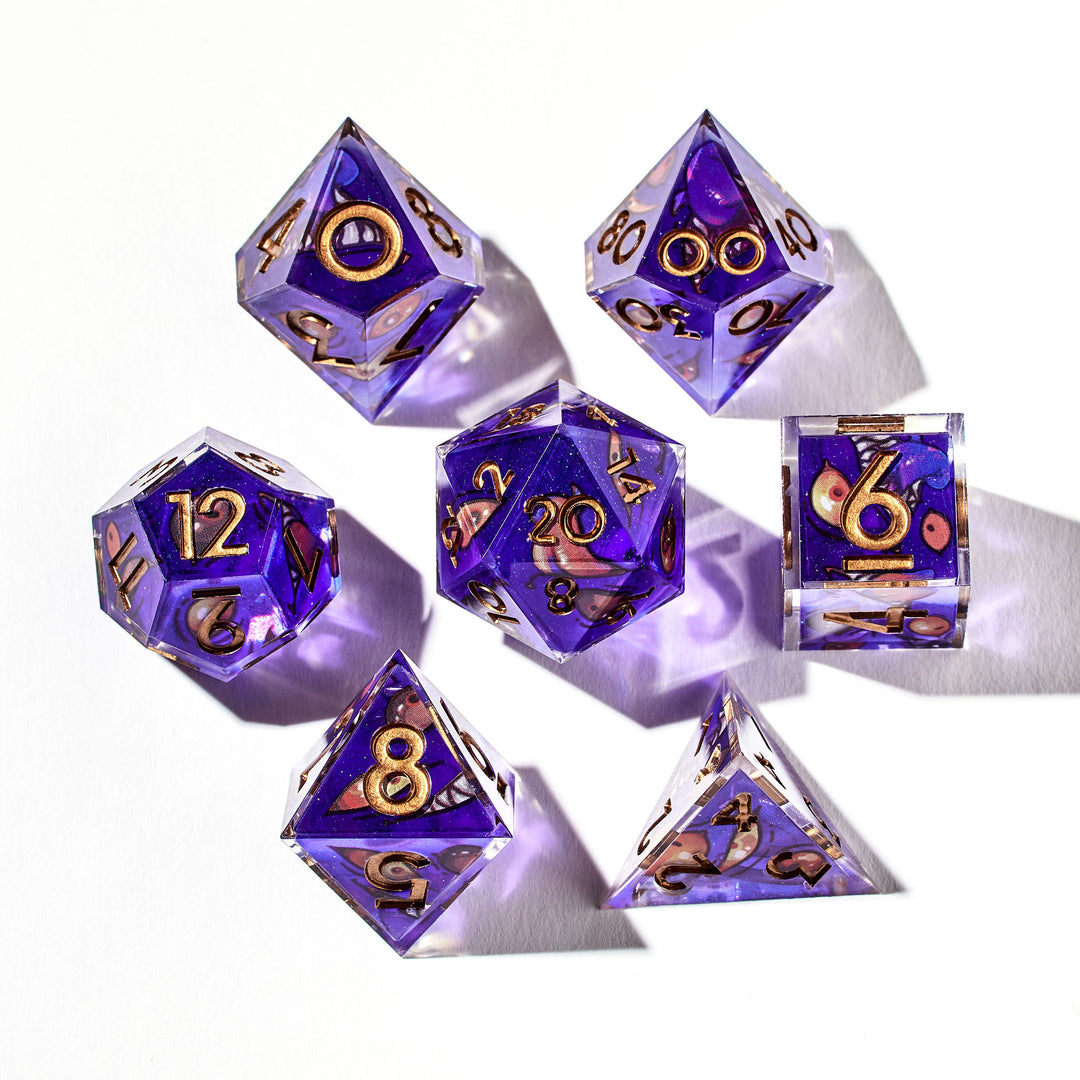 Close up of a purple dice set with mimic like designs