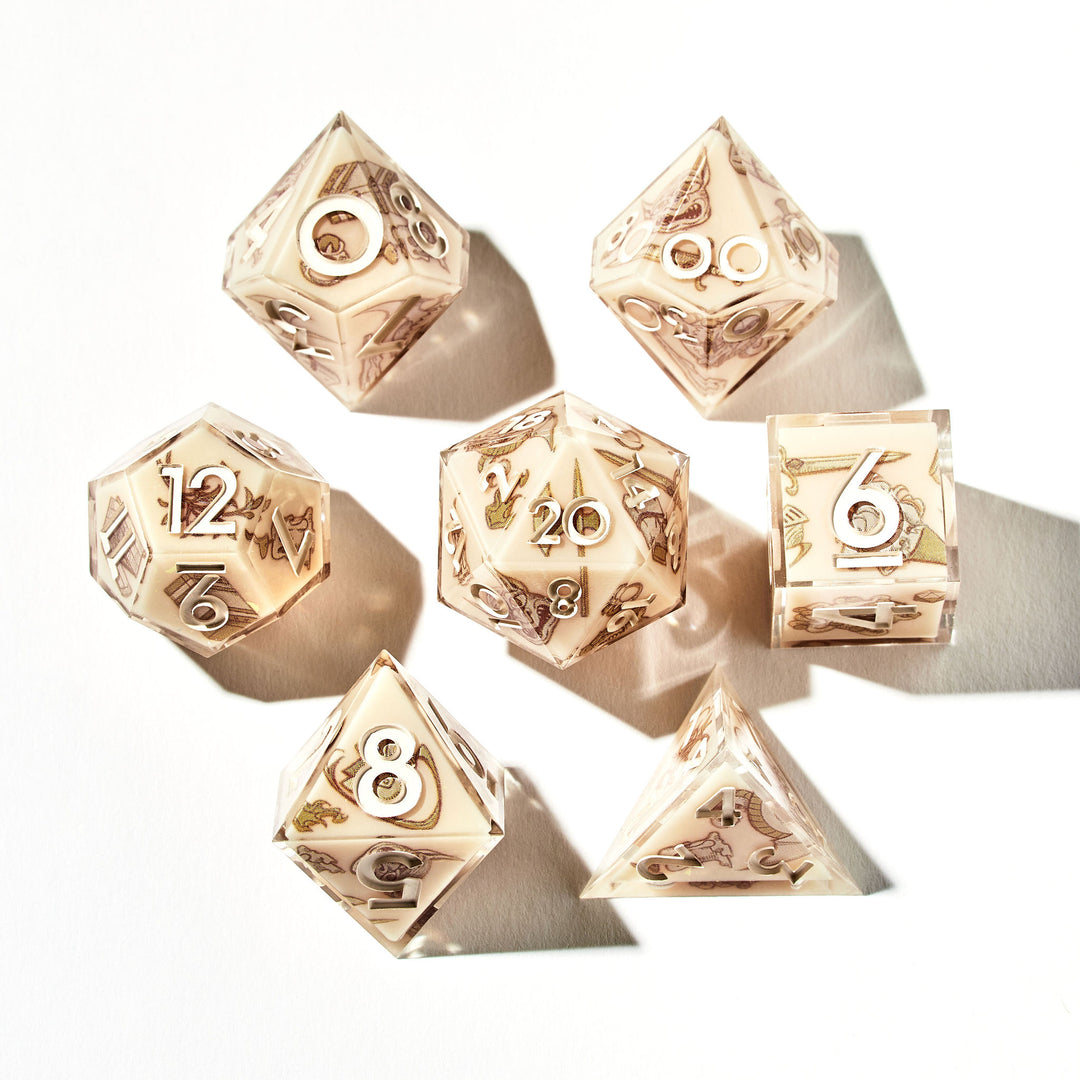 Close up of a beige dice set with sketch-like designs