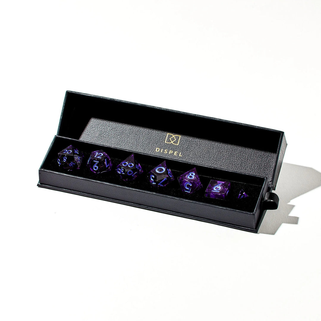 Picture of a full purple DnD dice set with a liquid core and light blue inked numbers inside the packaging