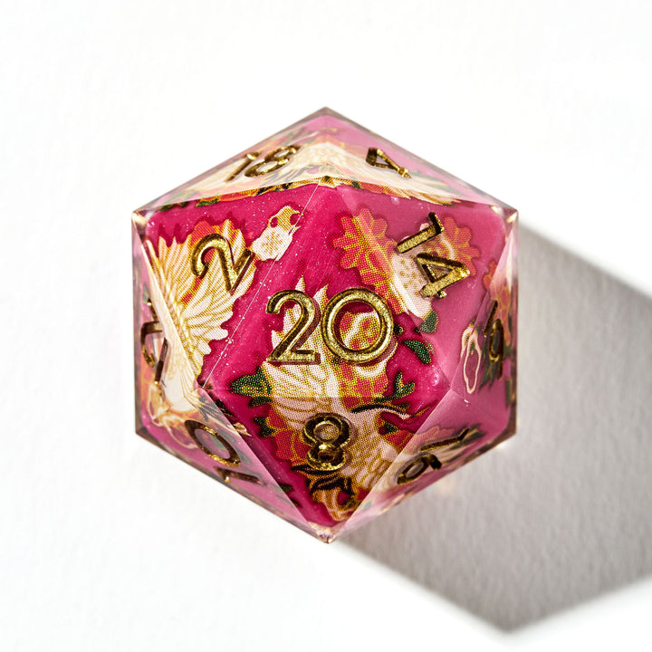 Close up of a red D20 die with Japanese art designs