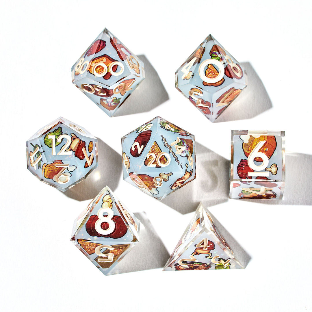 Close up of a set of dice with food from the anime Dungeon Meshi designs on each face